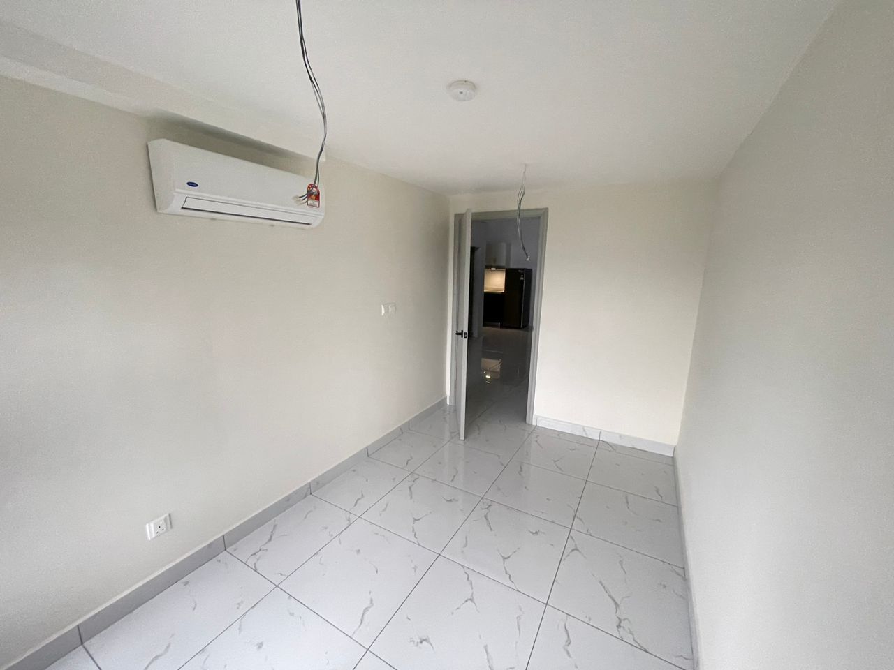 One of the two bedrooms in the unit, with air-conditioning unit installed